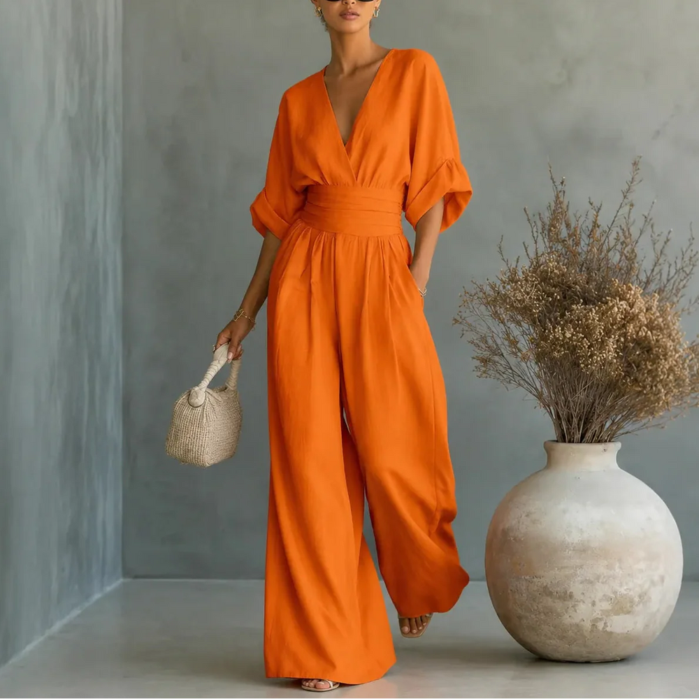 Soléra – Wide Leg V Neck Jumpsuit with Pleated Waist Sash