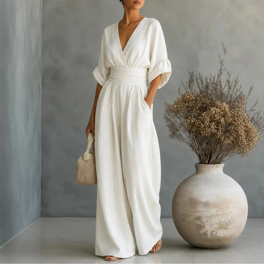 Soléra – Wide Leg V Neck Jumpsuit with Pleated Waist Sash