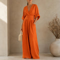 Soléra – Wide Leg V Neck Jumpsuit with Pleated Waist Sash