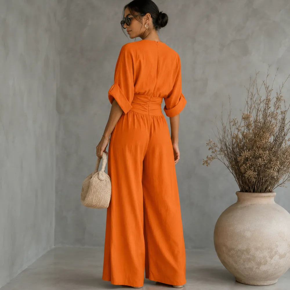Soléra – Wide Leg V Neck Jumpsuit with Pleated Waist Sash